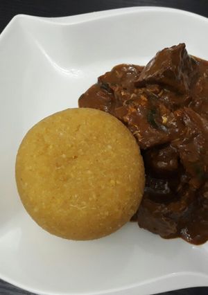 A picture of Ogbono soup with yellow eba.