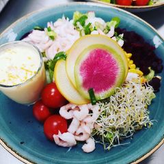 Shrimps salad served with sea-buckthorn berries dressing A picture of Shrimps salad served with sea-buckthorn berries dressing.