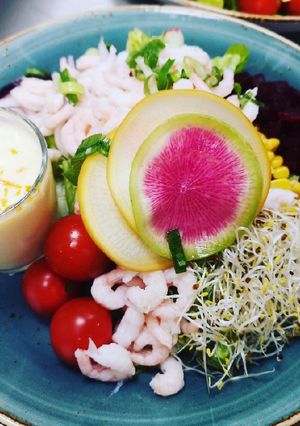 A picture of Shrimps salad served with sea-buckthorn berries dressing.