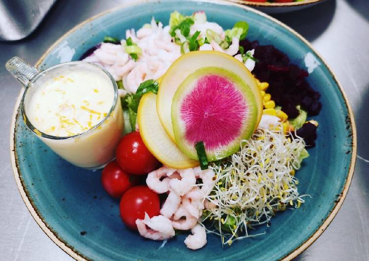 Shrimps salad served with sea-buckthorn berries dressing