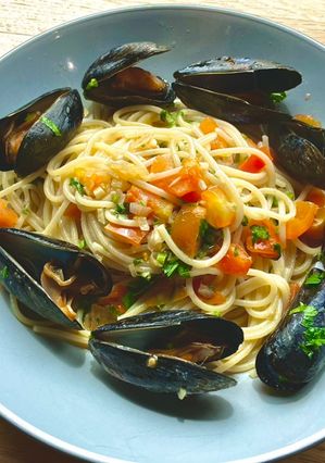 A picture of Pasta with mussels and tomatoes.