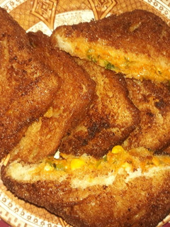 A picture of White sauce and vegetables triangles.