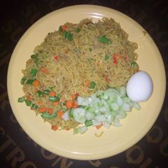 A picture of Vegetable noodles, egg and cubed cucumber.