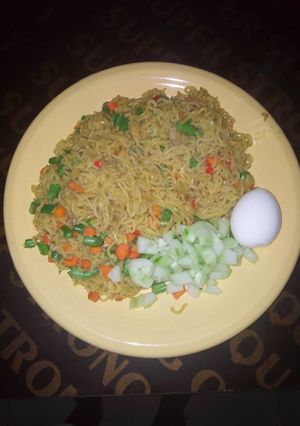 A picture of Vegetable noodles, egg and cubed cucumber.