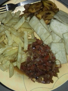 A picture of Fried yam,chips,fried plantain n sausage sauce.