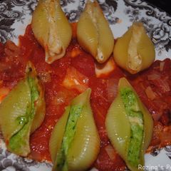 A picture of Stuffed pasta shells with cheese and spinach.