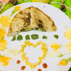 A picture of Corn spinach cheesy dosa.
