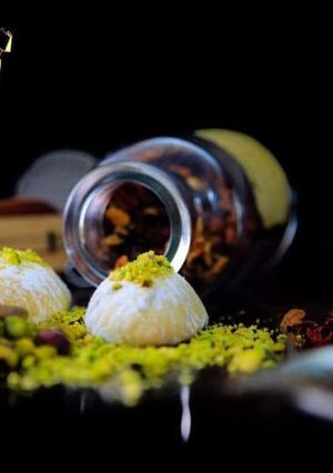 A picture of Maamoul cookies with pistachio, walnuts, and dates.