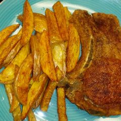 A picture of Pork Chops& Seasoned Fries.