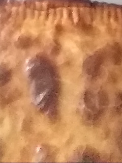 Una foto de Empanada cebolla caramelizada, morcilla y queso de cabra