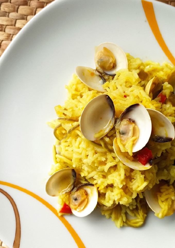 Una foto de Arroz basmati al curry con gulas y almejas