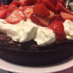 Decadent Chocolate Cake with Fresh Strawberries and Whipped Cream A picture of Decadent Chocolate Cake with Fresh Strawberries and Whipped Cream.