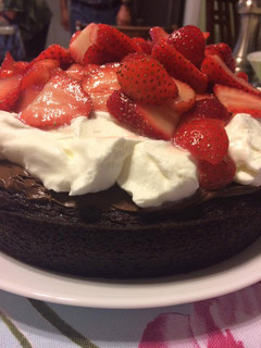 A picture of Decadent Chocolate Cake with Fresh Strawberries and Whipped Cream.