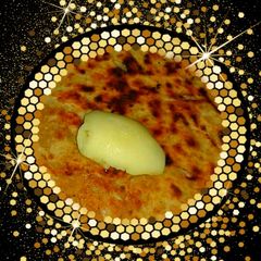 A picture of Paneer  paratha with  butter.