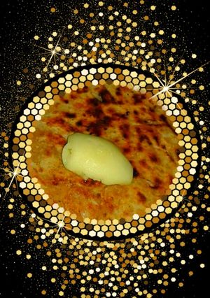 A picture of Paneer paratha with butter.