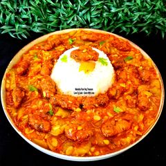 A picture of Methi Muthiya Tameta Galka Nu Shaak - Fist-Shaped Fried Methi Dumpling In Sponge Gourd Tomato Curry.