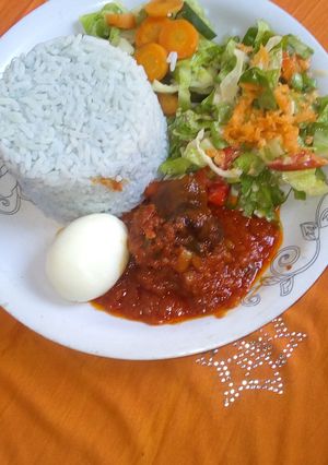 A picture of Blue rice and cowtail stew with coleslaw.