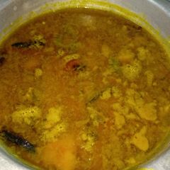 A picture of Moong Dal with fried fish head.