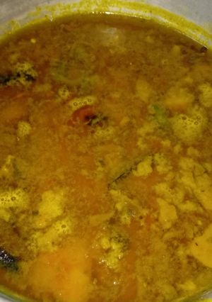 A picture of Moong Dal with fried fish head.