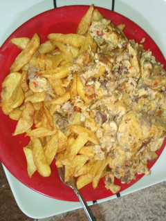 A picture of Fried chips with scrambled eggs.