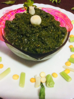 A picture of Green garlic mint leaves coriander chutney green chutney.