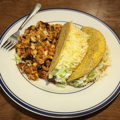 A picture of Cheesy Tex-Mex Rice and Tacos.