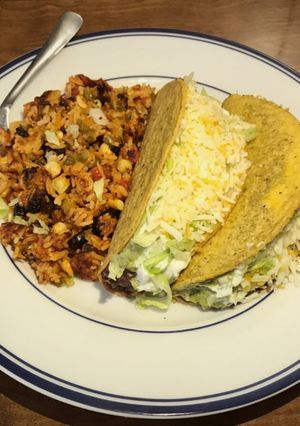 A picture of Cheesy Tex-Mex Rice and Tacos.