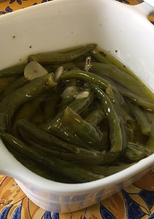 Une photo de Piments verts indiens confits à l'ail, herbes et citron