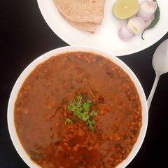 A picture of Moth Beans with Spinach and Jute Leaves (cooked with whey water).