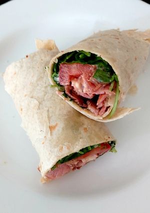 A picture of My Bacon,Tomato,Wild Rocket & soft cheese + Mayonnaise Wrap 😍.