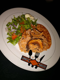 A picture of Jollof Rice & Beans, wif salad.