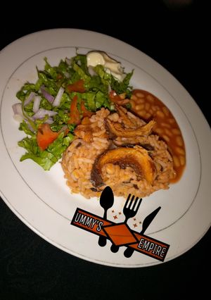 A picture of Jollof Rice & Beans, wif salad.
