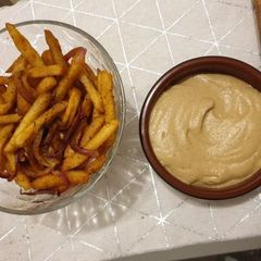 A picture of Baked Batata Harra fries with Baba Ganoush.
