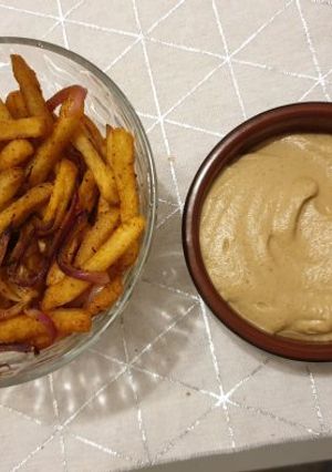 A picture of Baked Batata Harra fries with Baba Ganoush.