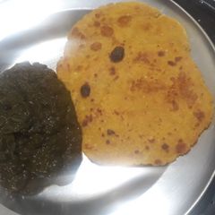 A picture of Sarso saag with makke ki roti.