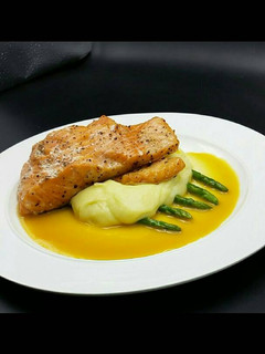 A picture of Seared salmon/mashed potatoes served with orange white wine sauc.