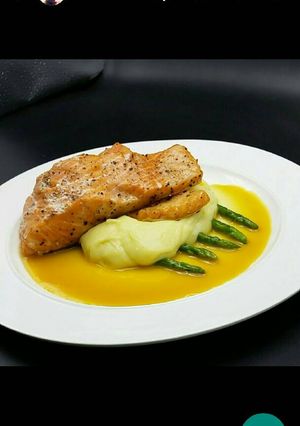 A picture of Seared salmon/mashed potatoes served with orange white wine sauc.