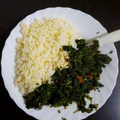 A picture of Left over Rice prepared with an egg and served with greens.
