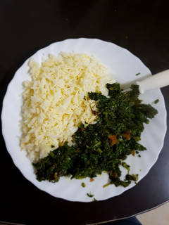A picture of Left over Rice prepared with an egg and served with greens.