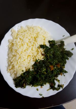 A picture of Left over Rice prepared with an egg and served with greens.