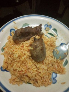 A picture of Jollof rice with chicken.