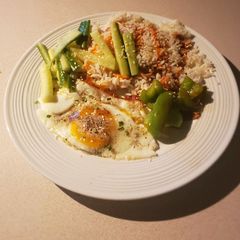 Rice with green veggies and a fried egg A picture of Rice with green veggies and a fried egg.