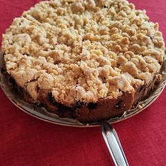 A picture of Crumble tart with cherry fruits.