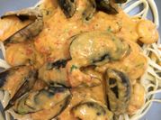 A picture of mussels with tomato sauce