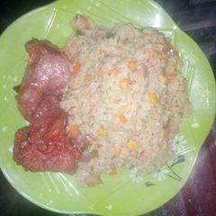 A picture of Coconut rice with peppered chicken.