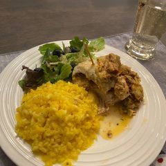 A picture of “Marry Me “ stuffed chicken w artichokes and sundried tomatoes w saffron risotto.