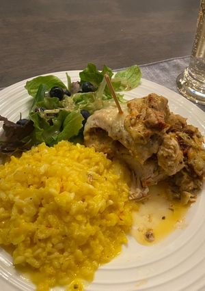A picture of “Marry Me “ stuffed chicken w artichokes and sundried tomatoes w saffron risotto.