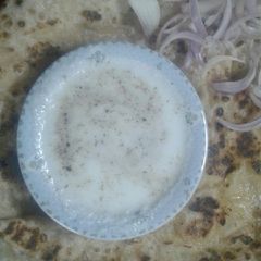 A picture of Potato paratha with yoghurt.