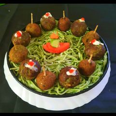 A picture of Green Falafel In Spaghetti Nests.