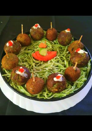 A picture of Green Falafel In Spaghetti Nests.